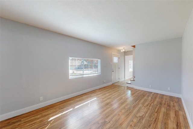 empty room with light hardwood / wood-style floors