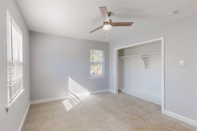 unfurnished bedroom featuring a closet, light colored carpet, and ceiling fan