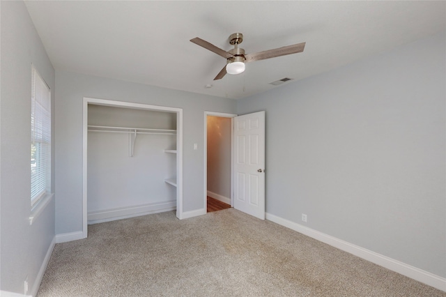 unfurnished bedroom featuring ceiling fan, light carpet, and a closet