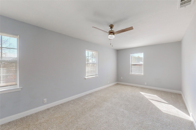 carpeted empty room featuring ceiling fan