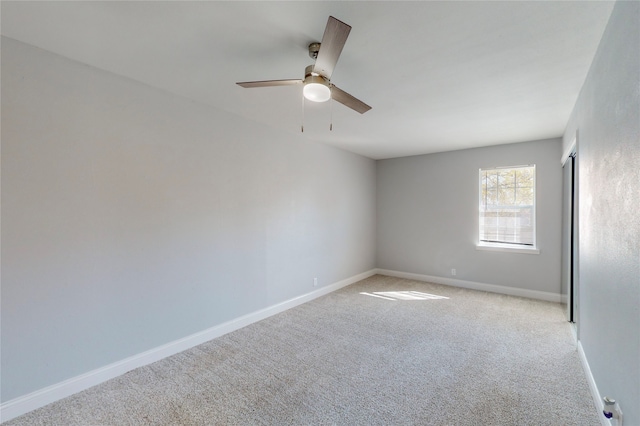 unfurnished room featuring light colored carpet and ceiling fan