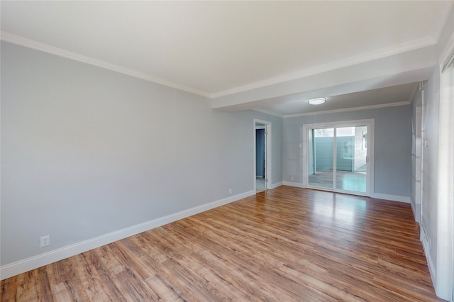 empty room with light hardwood / wood-style floors and crown molding