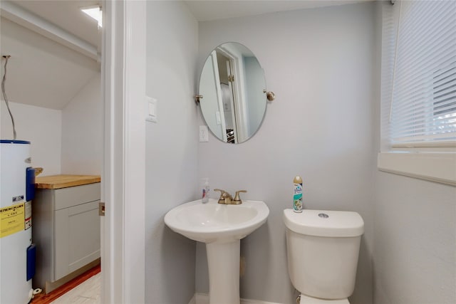 bathroom featuring electric water heater and toilet