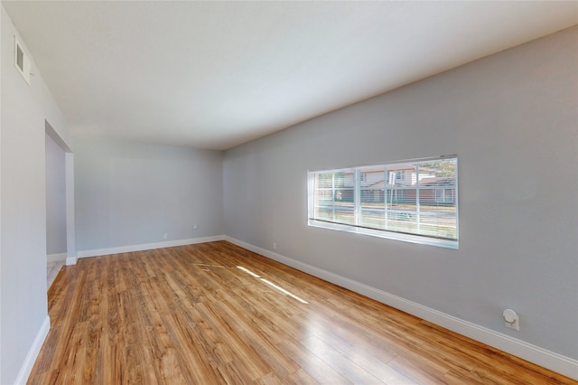 unfurnished room with light hardwood / wood-style floors