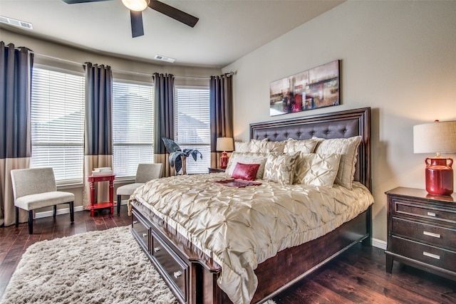 bedroom featuring dark wood-type flooring, ceiling fan, and multiple windows