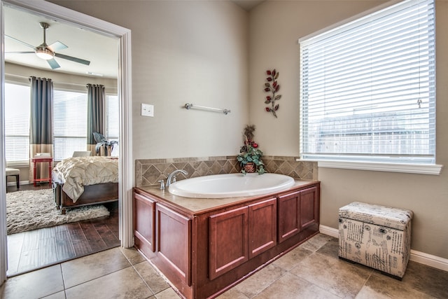 bathroom featuring a tub, tile patterned flooring, ceiling fan, and plenty of natural light