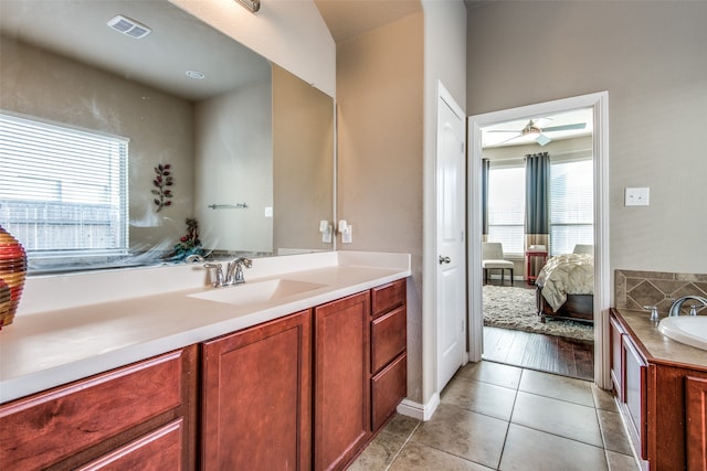 bathroom with a wealth of natural light, ceiling fan, vanity, and hardwood / wood-style flooring