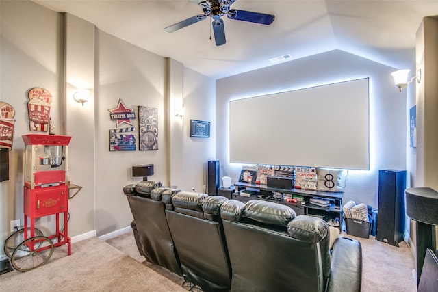 home theater with light carpet, ceiling fan, and vaulted ceiling