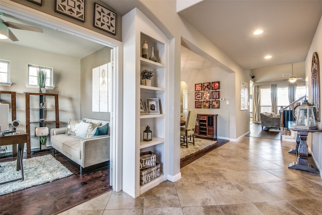 interior space featuring built in shelves, light wood-type flooring, and a wealth of natural light