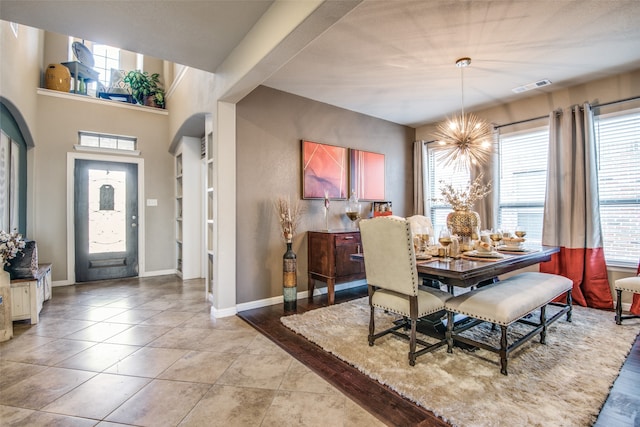 dining room featuring a chandelier and light tile patterned floors