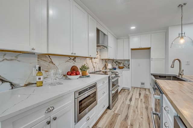 kitchen featuring wood counters, white cabinetry, and appliances with stainless steel finishes