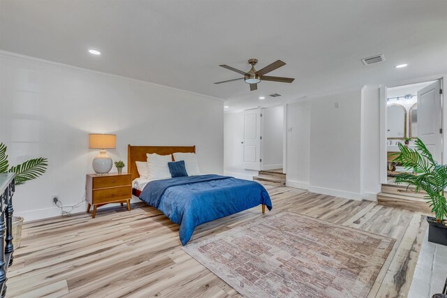 bedroom with ornamental molding, light wood-type flooring, and ceiling fan