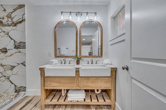 bathroom with a shower, hardwood / wood-style flooring, and vanity