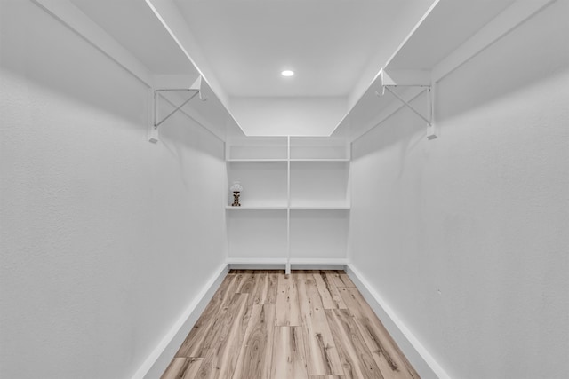 walk in closet with light wood-type flooring