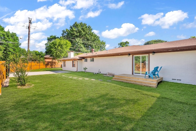 rear view of house featuring a yard