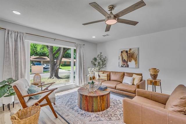 living room featuring ceiling fan and light hardwood / wood-style floors