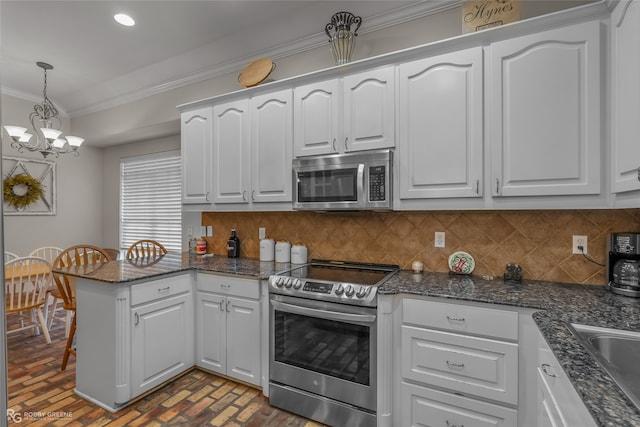 kitchen featuring tasteful backsplash, white cabinetry, appliances with stainless steel finishes, pendant lighting, and kitchen peninsula