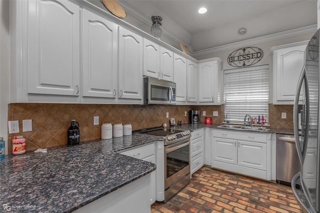 kitchen with stainless steel appliances, white cabinetry, sink, and decorative backsplash