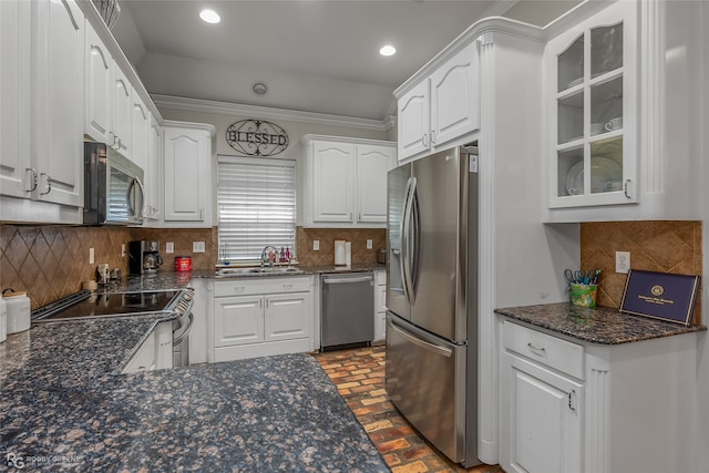 kitchen with stainless steel appliances, white cabinets, sink, and tasteful backsplash