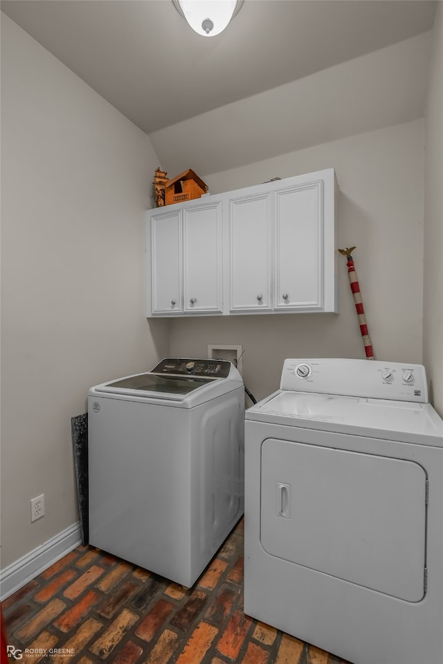 washroom with cabinets and washer and clothes dryer