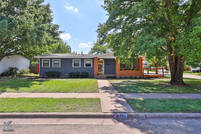 ranch-style home featuring a front yard