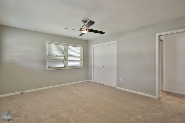 unfurnished bedroom with light carpet, ceiling fan, and a closet