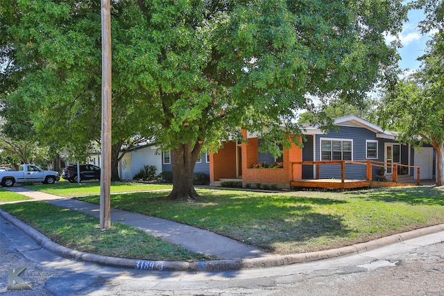 view of front of property with a front yard and a deck