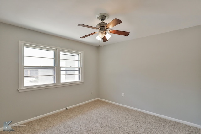 empty room with ceiling fan and carpet