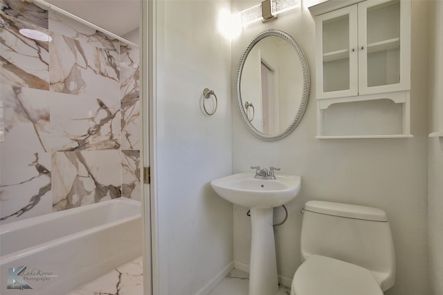 bathroom featuring toilet and tiled shower / bath combo