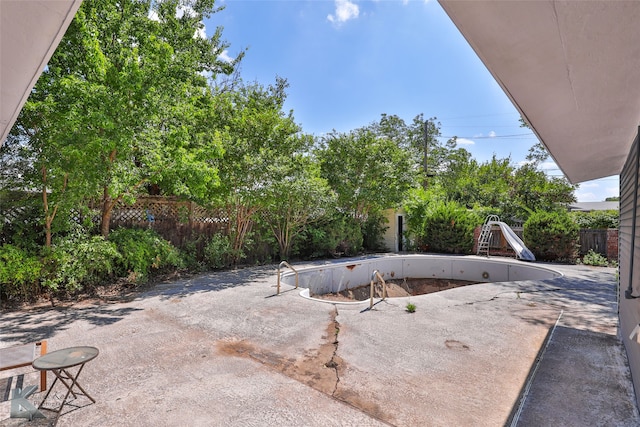 view of pool featuring a patio area and a water slide