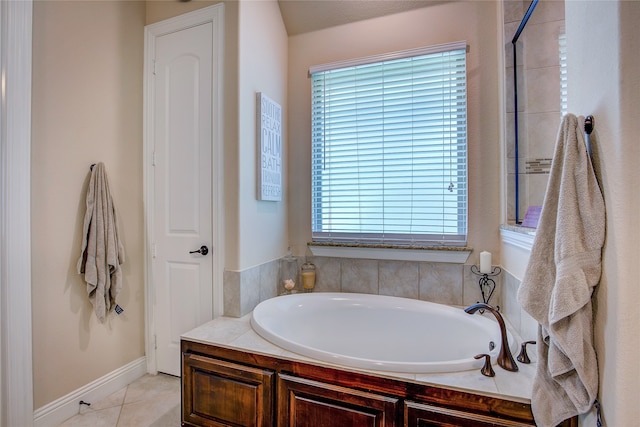 bathroom featuring tile patterned flooring, a bathtub, and a healthy amount of sunlight