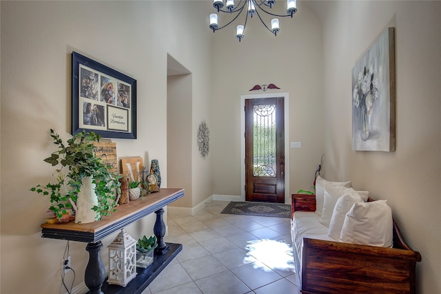 tiled foyer with a high ceiling and a notable chandelier