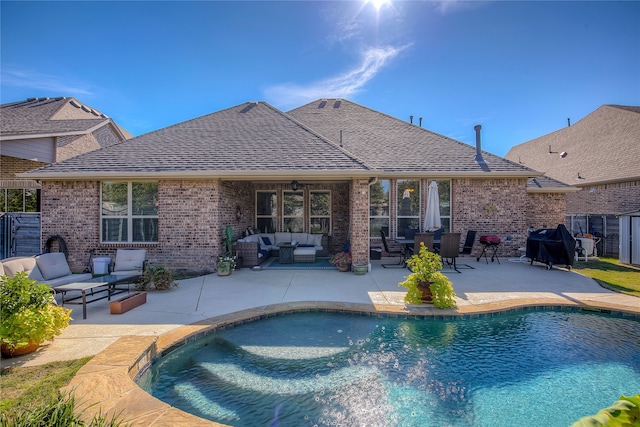 view of swimming pool with outdoor lounge area, a patio area, and area for grilling