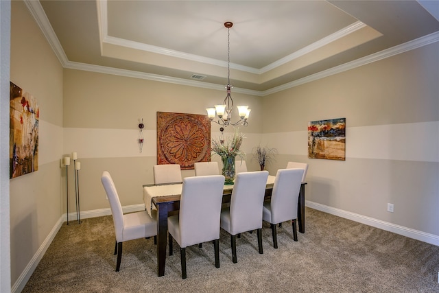 carpeted dining room with a tray ceiling, crown molding, and a notable chandelier