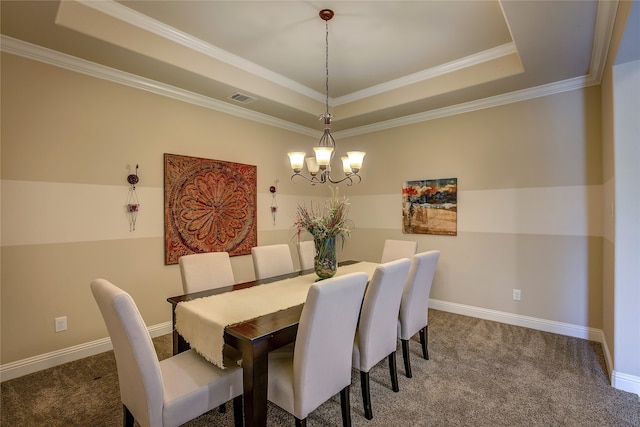 dining room with carpet floors, a raised ceiling, and ornamental molding