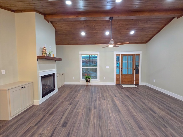 unfurnished living room with lofted ceiling with beams, a fireplace, baseboards, and dark wood-type flooring