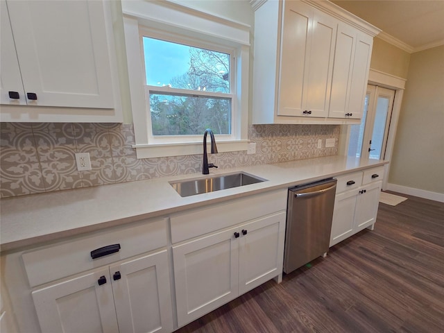 kitchen with white cabinets, light countertops, a sink, and stainless steel dishwasher