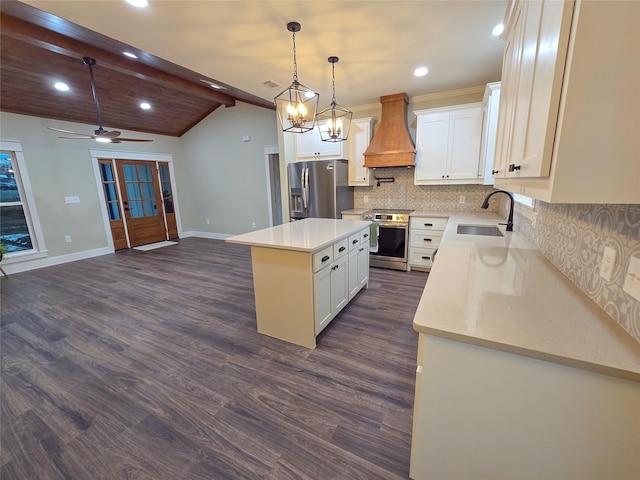 kitchen with a center island, stainless steel appliances, custom range hood, decorative backsplash, and a sink