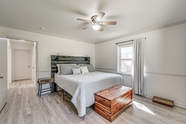 bedroom featuring crown molding, ceiling fan, and light hardwood / wood-style floors