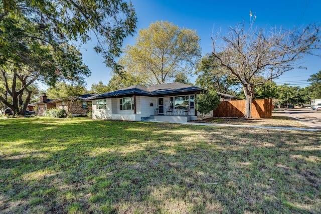 back of property with a porch and a yard