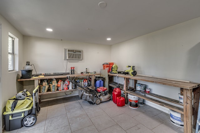 miscellaneous room with light tile patterned floors and an AC wall unit