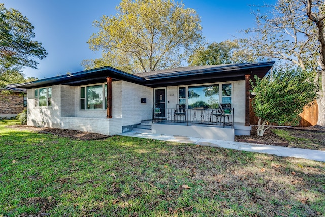 single story home with a front yard and covered porch