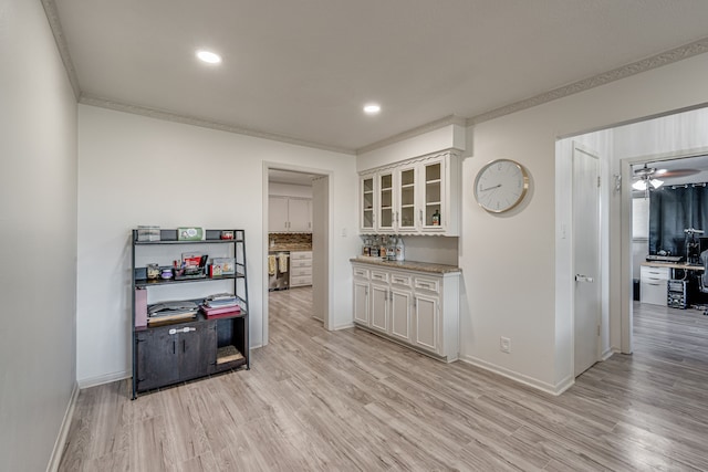 kitchen featuring light hardwood / wood-style floors, ornamental molding, stainless steel dishwasher, ceiling fan, and white cabinetry