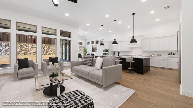 unfurnished living room with french doors, ceiling fan, and light hardwood / wood-style floors