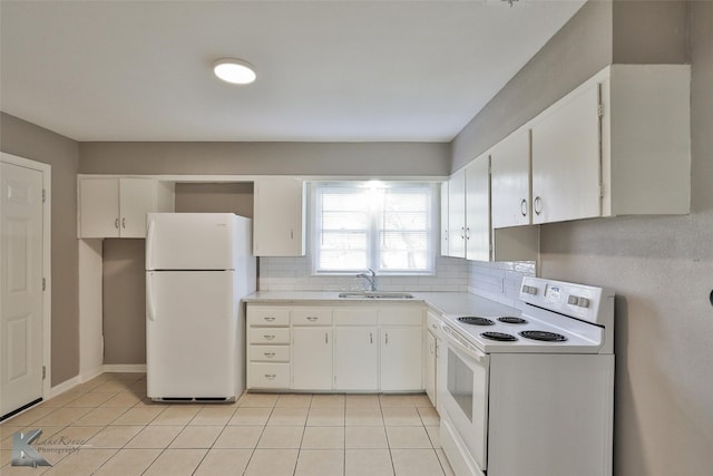 kitchen with white appliances, white cabinets, light tile patterned flooring, and sink