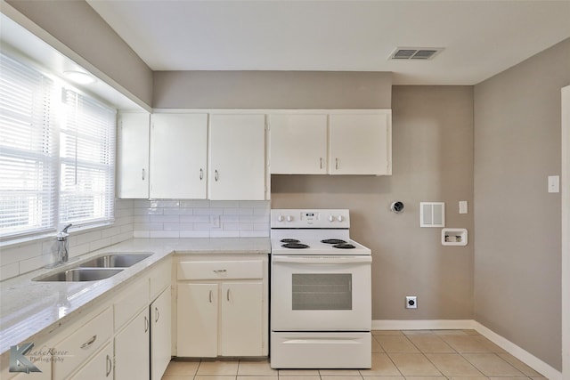 kitchen with sink, white cabinets, light tile patterned floors, white range with electric stovetop, and backsplash