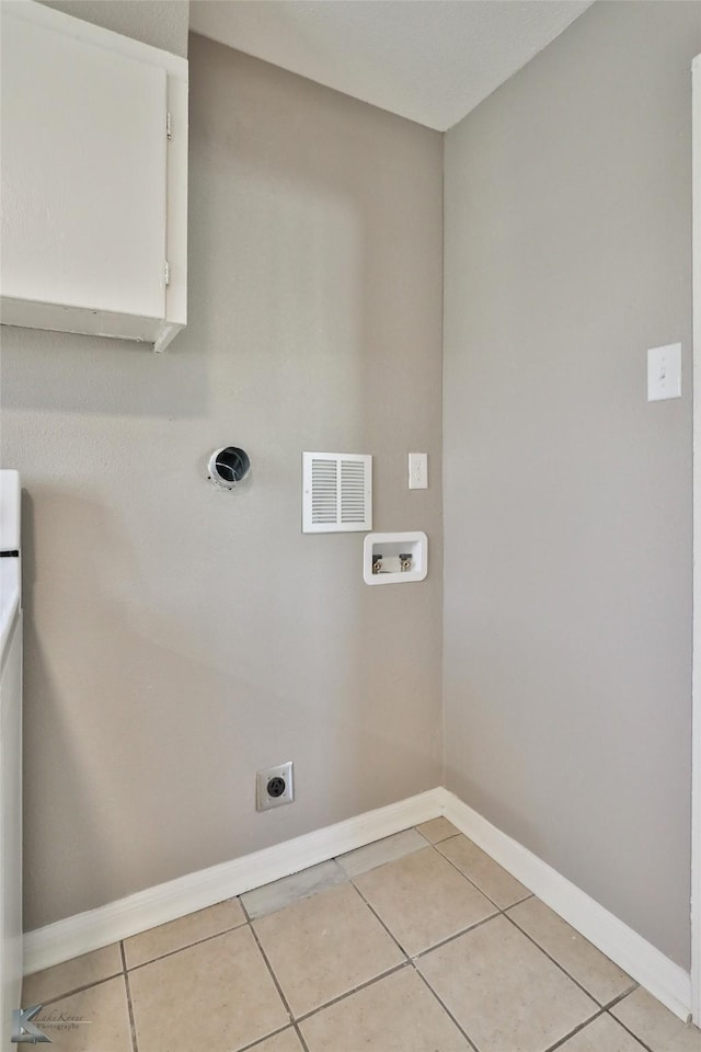 washroom with washer hookup, hookup for an electric dryer, and light tile patterned floors