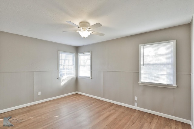 spare room with ceiling fan and light hardwood / wood-style floors