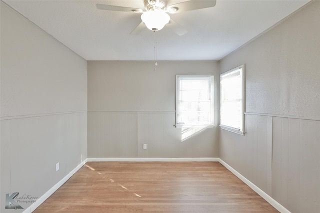 empty room featuring ceiling fan and light hardwood / wood-style flooring