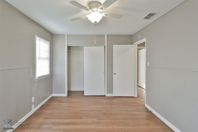 unfurnished bedroom featuring ceiling fan, light hardwood / wood-style flooring, and a closet